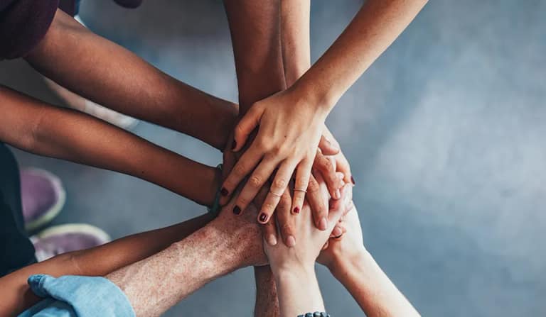 Hands stacked together in a show of support