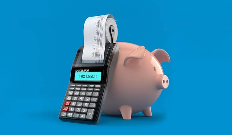 A piggy bank beside a calculator printing a tax credit receipt